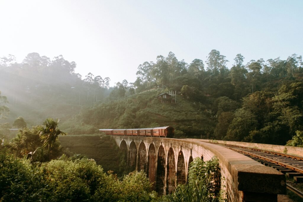 pexels-photo-2403209-2403209 Scenic view of Nine Arches Bridge with train passing through lush greenery in Sri Lanka.