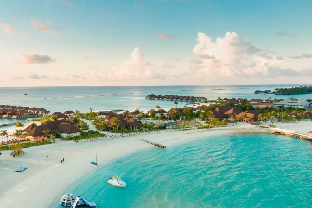 pexels-photo-3601425-3601425 A stunning aerial view of a tropical Maldives beach with clear turquoise waters and resorts along the shore.